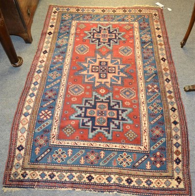 Lot 1235 - Lesghi rug, East Caucasus, The madder field with three typical stars, enclosed by pale indigo...