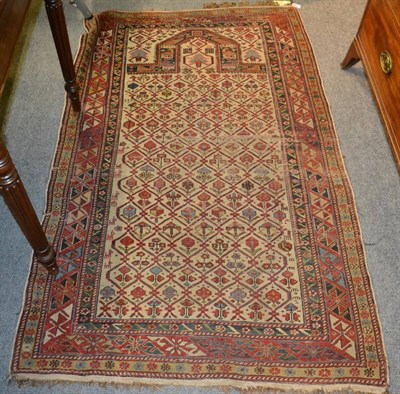 Lot 1238 - Daghestan prayer rug, East Caucasus, The ivory lattice field of stylised plants beneath the...