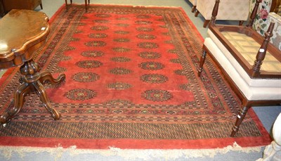 Lot 1239 - Turkmen style carpet, possibly Lahore, The crimson field with columns of salor guls enclosed by...