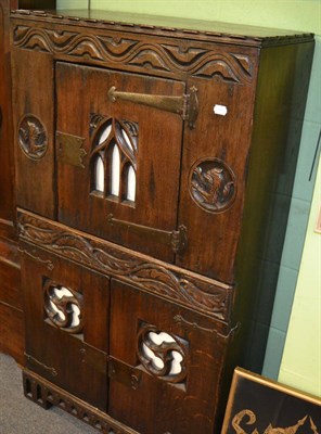 Lot 1240 - A reproduction carved oak cupboard