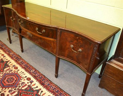 Lot 1242 - A George III mahogany serpentine fronted sideboard