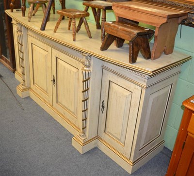 Lot 1252 - A period style painted parcel gilt bow fronted sideboard