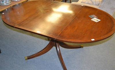 Lot 1291 - A 19th century mahogany dining table and a mahogany pedestal table