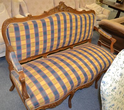 Lot 1293 - An early 20th century French style two seater open arm sofa with checkered upholstery