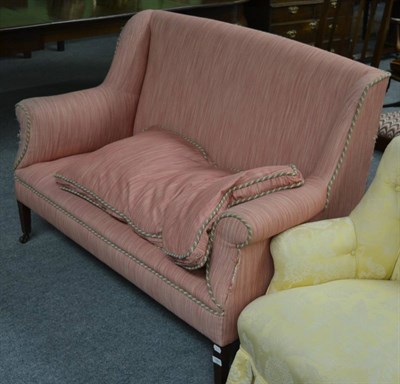 Lot 1301 - An Edwardian two seater sofa in pink upholstery