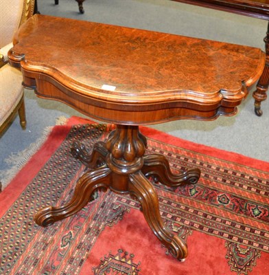 Lot 1308 - A Victorian burr walnut fold over card table