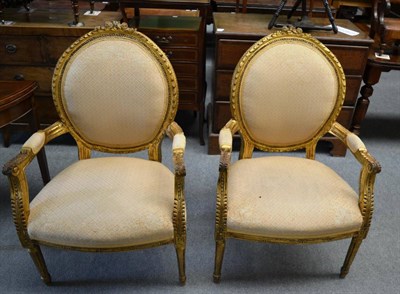 Lot 1309 - A pair of Louis XVI style gilt fauteuils