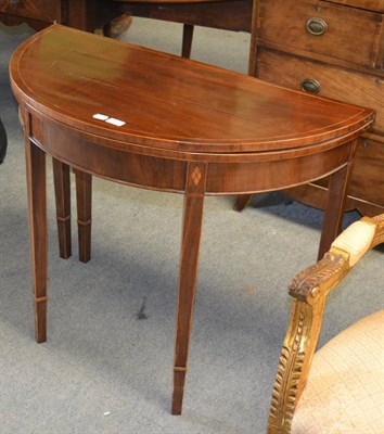 Lot 1310 - An early 19th century mahogany demi-lune fold over tea table, 92cm wide, 73cm high