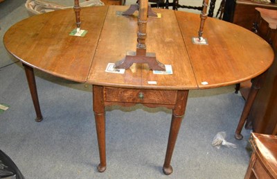 Lot 1311 - A Georgian oak pad foot gateleg dining table