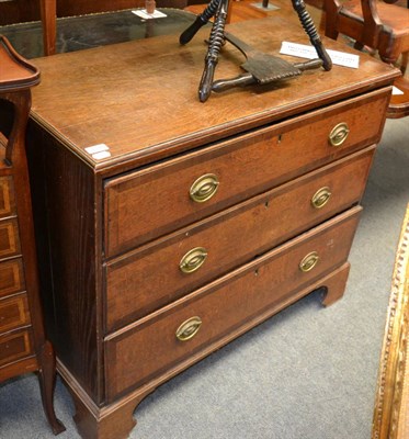 Lot 1315 - A Georgian oak three drawer chest of drawers