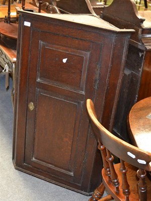 Lot 1333 - George III panelled oak hanging corner cupboard