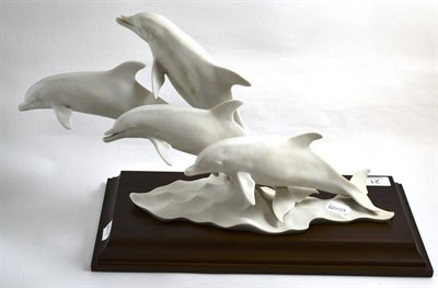 Lot 21 - A large Kaiser parian group of four leaping dolphins on hardwood plinth