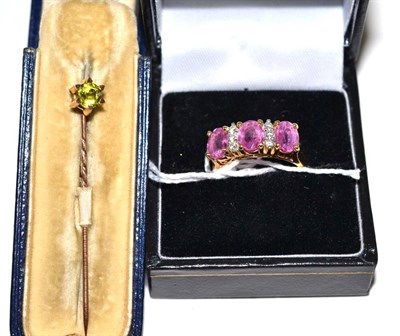 Lot 86 - A pink stone diamond ring and a peridot stick pin