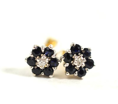 Lot 104 - A pair of diamond and sapphire cluster stud earrings