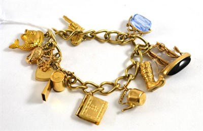 Lot 110 - A 9ct gold curb link charm bracelet, with attached 9ct gold charms