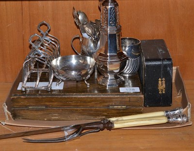 Lot 138 - A collection of silver and silver plate including a pair of silver toast racks, sugar caster,...