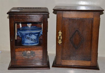 Lot 156 - Two oak smokers cabinets, one with pottery tobacco jar and three clay pipes