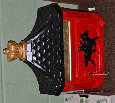 Lot 161 - A red and black painted wall mounted letter box