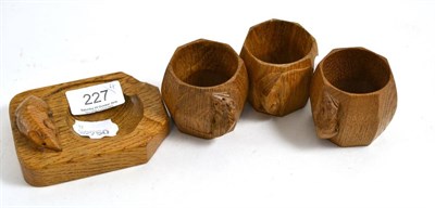 Lot 227 - Three Mouseman oak napkin rings and an ashtray (4)