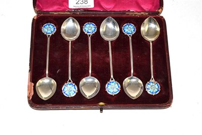 Lot 238 - A cased set of six silver teaspoons with blue enamel floral terminals