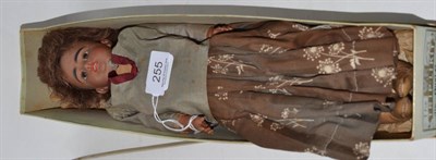 Lot 255 - A mulatto doll with bisque head and leather body