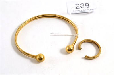 Lot 269 - A 9ct gold torque bangle, a 9ct gold bond ring (cut a.f.)