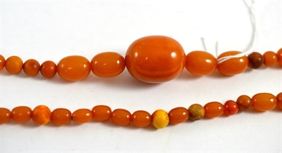 Lot 270 - A continuous amber bead necklace, length 32cm, size of largest bead 3.5cm by 2cm