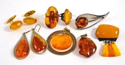 Lot 297 - Two amber rings, two amber pendants, two amber brooches, pair of amber earrings and a pair of amber