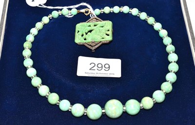 Lot 299 - A graduated jade bead necklace, with faceted white spacer beads, and a carved jade and...