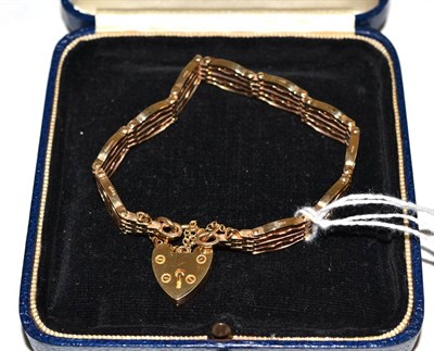 Lot 302 - A 9ct gate link bracelet with padlock