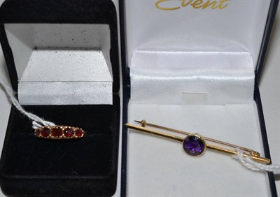 Lot 303 - An amethyst bar brooch, stamped '15ct' and a 9ct gold garnet five stone ring (2)