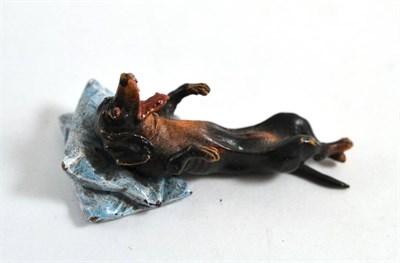 Lot 305 - A cold painted bronze of dachshund lying on a pillow