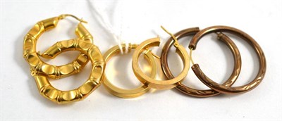 Lot 310 - Three pairs of 9ct gold hoop earrings (3)