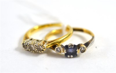 Lot 338 - An 18ct gold diamond three stone ring and a sapphire and diamond three stone ring stamped...