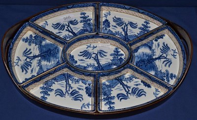 Lot 366 - A Booth's Old Willow pattern hors d'oeuvre set, seven segments within oval twin handled...