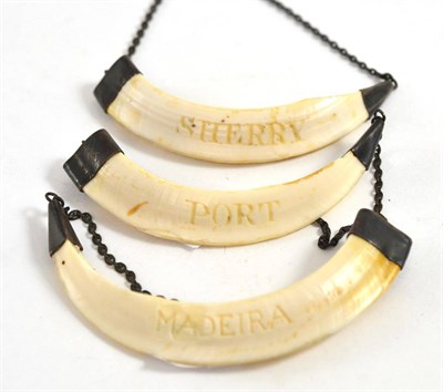 Lot 385 - A set of three late 19th century bore tusk ivory spirit labels