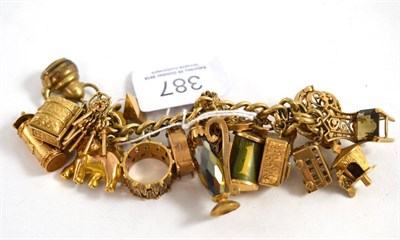 Lot 387 - A 9ct gold charm bracelet with nineteen charms dependant