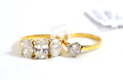 Lot 405 - A 14ct gold cubic zirconia solitaire ring and a 14ct cubic zirconia three stone ring (2)