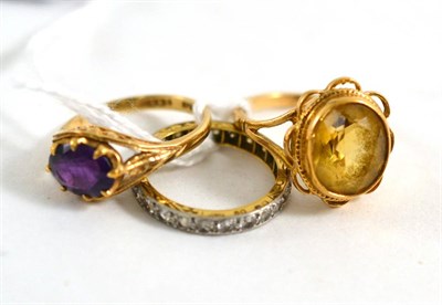 Lot 406 - A 9ct gold amethyst ring, a 9ct gold citrine ring and a white stone eternity ring (3)