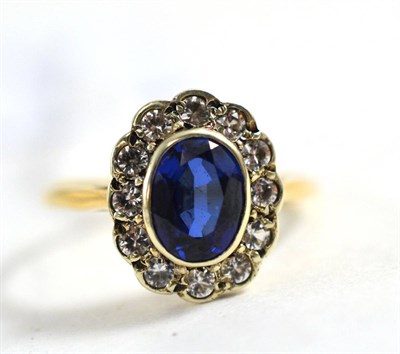 Lot 415 - A synthetic sapphire and white stone cluster ring