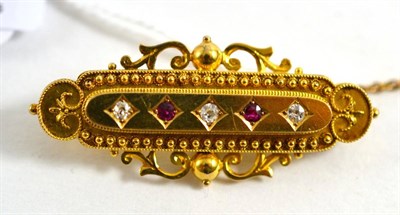 Lot 423 - A Victorian ruby and old cut diamond brooch, with safety chain