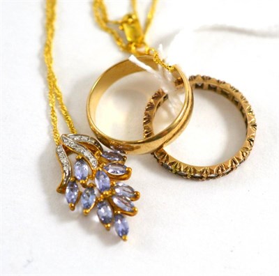 Lot 425 - A 9ct gold tanzanite and diamond necklace, a 9ct gold band ring and an eternity ring (3)