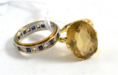 Lot 450 - A 9ct gold citrine ring and a 9ct gold sapphire eternity ring (2)