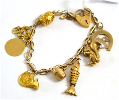 Lot 462 - A 9ct gold charm bracelet with 9ct and other charms