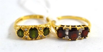 Lot 469 - An 18ct gold green stone and diamond ring, and an 18ct gold garnet and diamond ring (2)