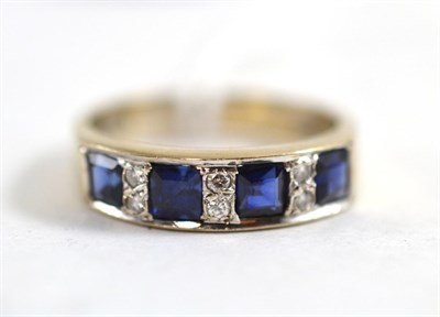 Lot 476 - An 18ct white gold sapphire and diamond half hoop ring