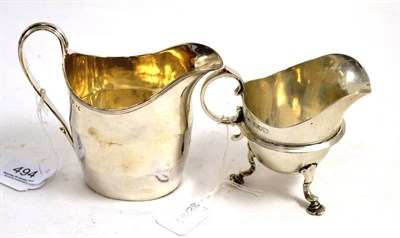 Lot 494 - A George III silver helmet form cream jug, together with another silver cream jug (2)