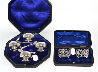 Lot 501 - Cased set of four silver pedestal salts, with spoons, and a cased pair of oval silver salts,...