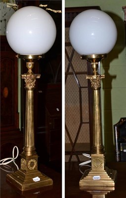 Lot 508 - A pair of brass Corinthian columnar table lamps