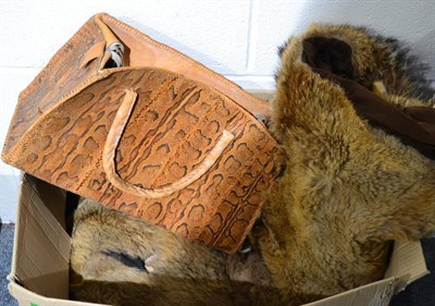 Lot 1003 - An animal skin mounted car rug, probably made from coyote, on a brown felt backing, 140cm by 108cm